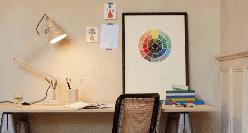 Minimalist desk with lamp and artwork.